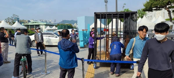 전남도청 앞에 있는 전두환 전)대통령 흉상에 뿅망치를 들고 시민들이 때리는 퍼포먼스를 하고 있다.(사진 / 박영용 기자)