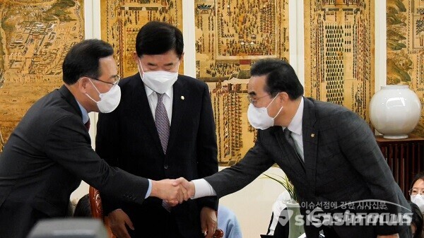 김진표 국회의장 주재로 16일 오후 국회 의장실에서 열린 여야 원내대표 회동에서 국민의힘 주호영 원내대표와 더불어민주당 박홍근 원내대표가 악수하고 있다. 가운데는 김진표 국회의장. 사진 / 김기범 기자
